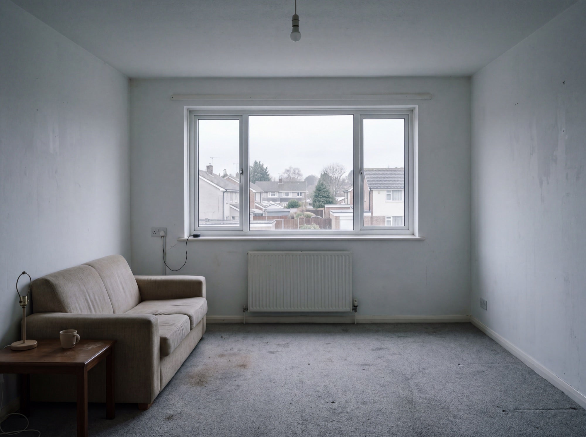 Living room before: bare window, flat light